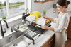Woman loading dishes in bright kitchen
